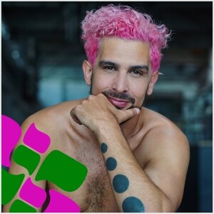 Headshot of a man with pink hair