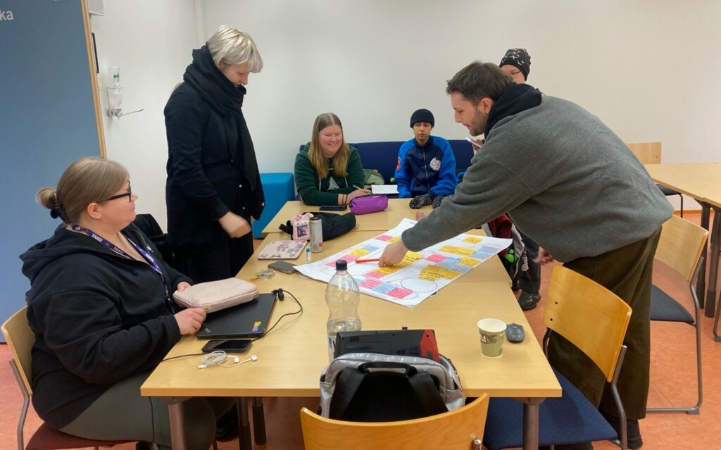 Group of people working around a desk