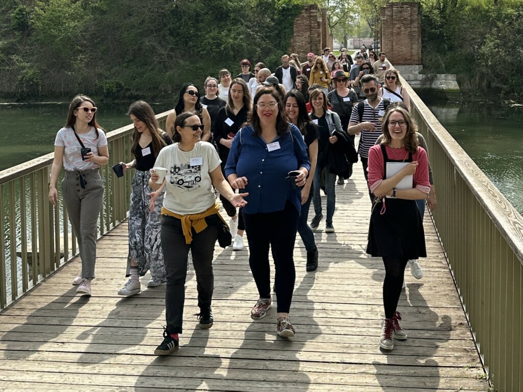 Group of people walking on a wooden bridge