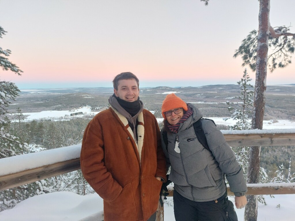 Two people standing in a winter scenery in Lapland